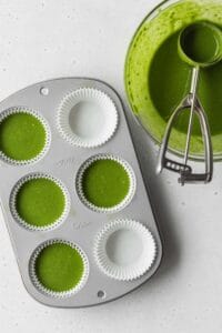 Pour the matcha cake batter into the muffin pan using an ice cream scoop