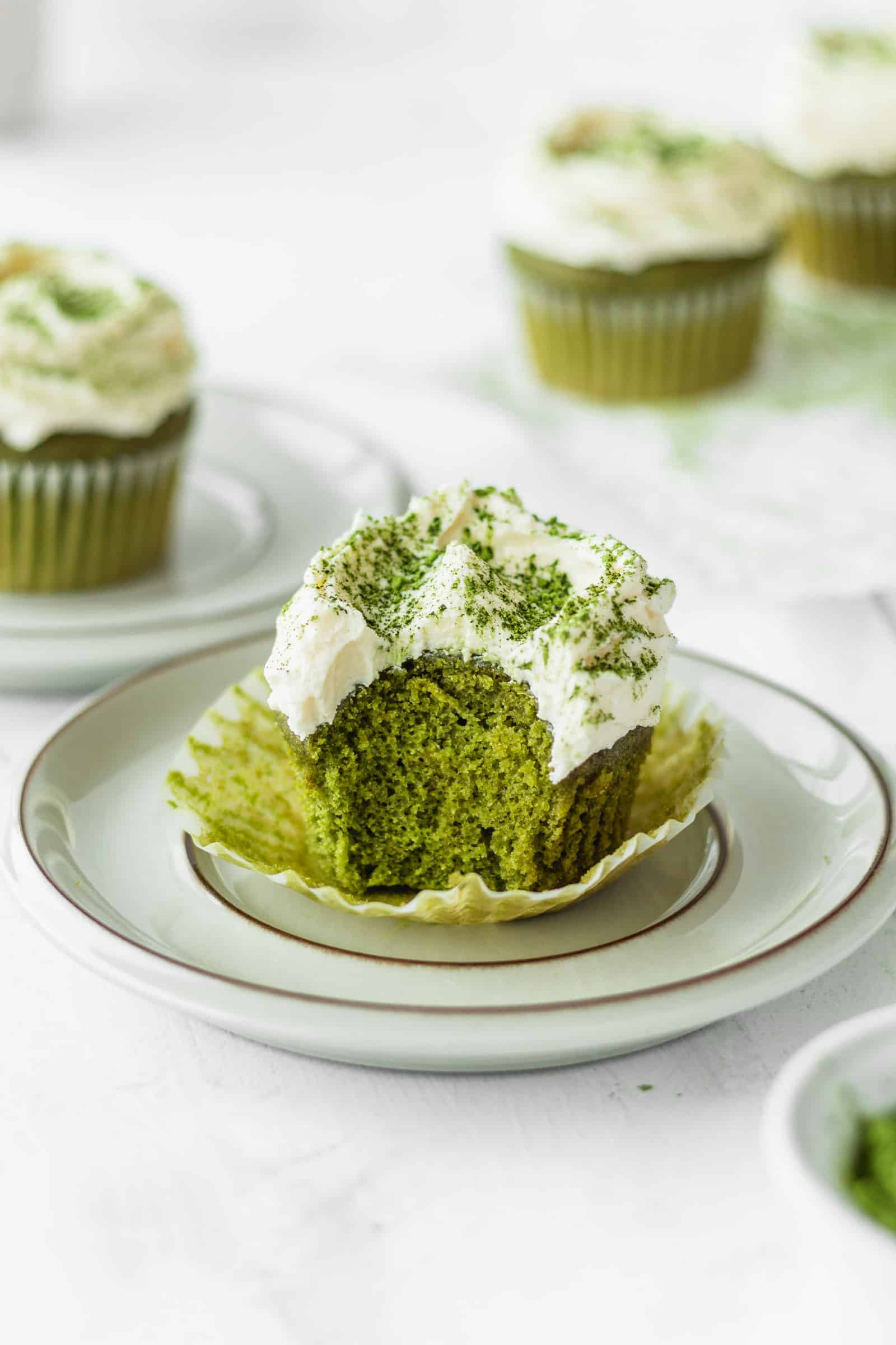 Fluffy green tea cupcake with a bite taken out