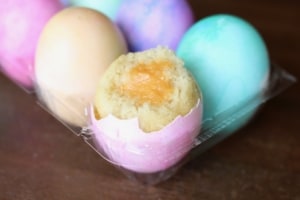 Easter cupcakes baked in eggshells! There's a surprise yolk inside made from carrot curd. #easter #cupcakes