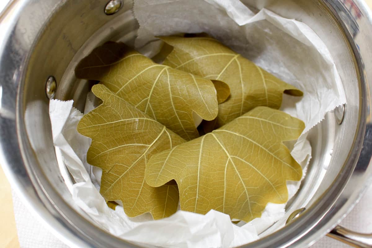 Kashiwa wrapped mochi added to a parchment-lined steamer.