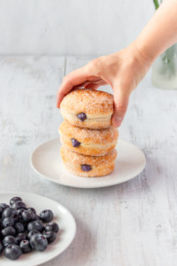 Super fluffy melt-in-your-mouth doughnuts, or donuts, that come together in a bread machine! They’re filled with a delicious blueberry cream cheese filling! #blueberry #creamcheese #doughnuts #donuts #breadmachine