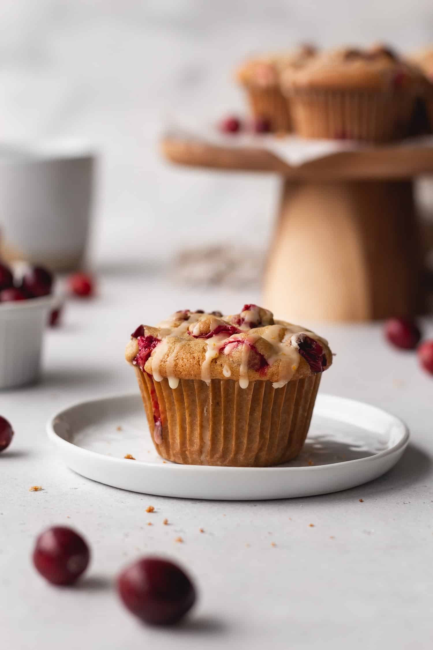 A cranberry orange muffin on a white plate