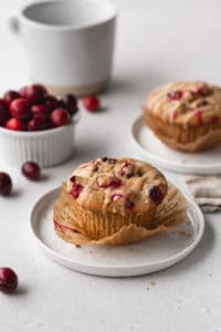 A gluten free dairy free cranberry orange muffin on a plate