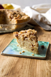 Flaky crust filled with deliciously spiced apples and topped with crunchy oat pecan streusel topping. Can this apple pie get any better? #applepie #oatstreusel #pecans #singlecrust #flaky #piecrust #butter #apples #thanksgiving #christmas #holiday #fall #autumn #winter #dessert #recipe