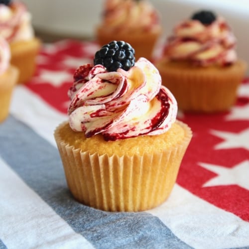These corn cupcakes are jam packed with corn! There’s corn in the fluffy cupcakes, and corn in the silky buttercream frosting, kissed with tart and fruity blackberries! It’s the perfect cupcake to serve at your Fourth of July BBQ! #corn #corncupcakes #cornmuffins #cornfrosting #frosting #buttercream #blackberry #blackberries #fourthofjuly #fluffy #moist #4thofjuly #independenceday #bbq #barbecue #july #summer