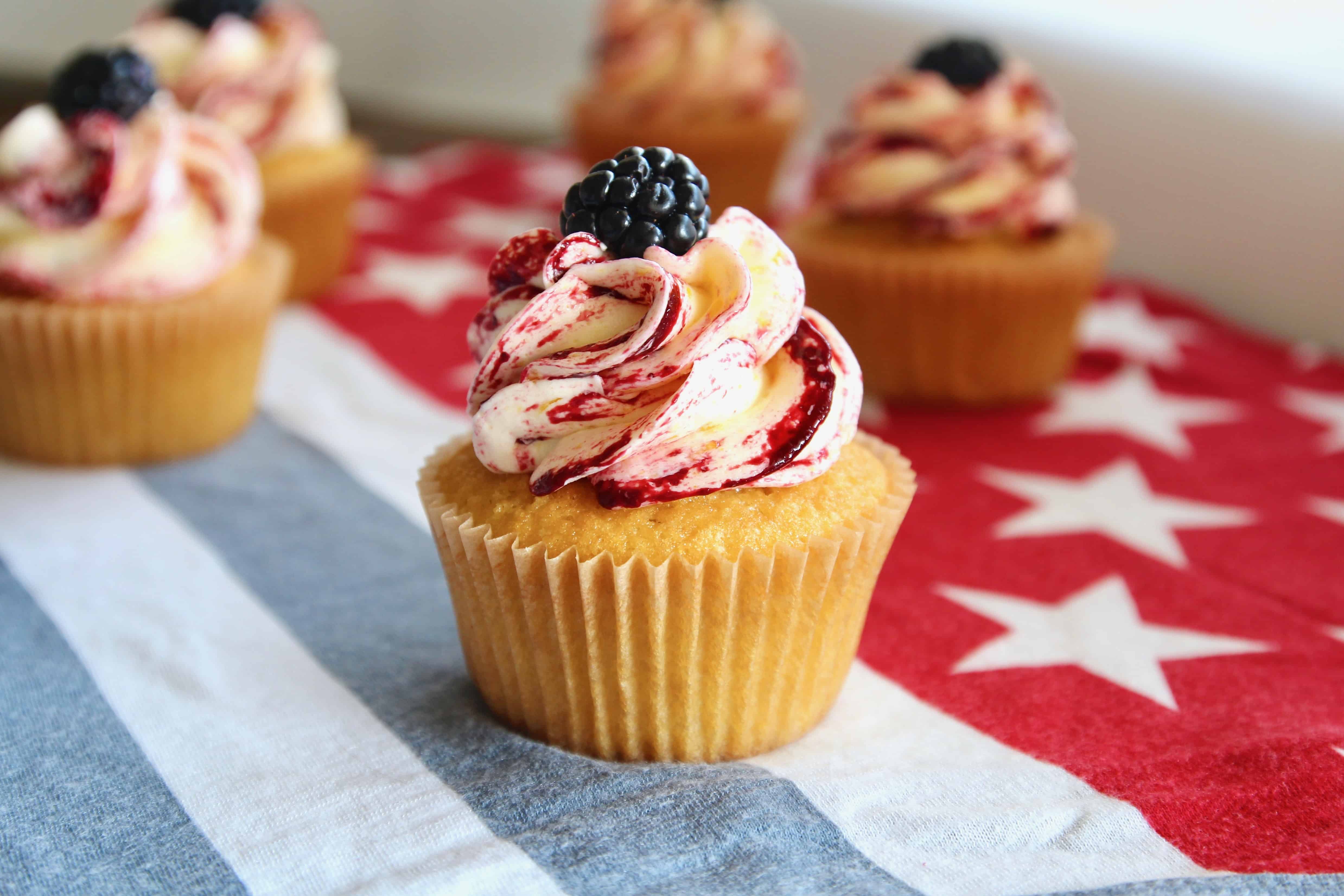 These corn cupcakes are jam packed with corn! There’s corn in the fluffy cupcakes, and corn in the silky buttercream frosting, kissed with tart and fruity blackberries! It’s the perfect cupcake to serve at your Fourth of July BBQ! #corn #corncupcakes #cornmuffins #cornfrosting #frosting #buttercream #blackberry #blackberries #fourthofjuly #fluffy #moist #4thofjuly #independenceday #bbq #barbecue #july #summer