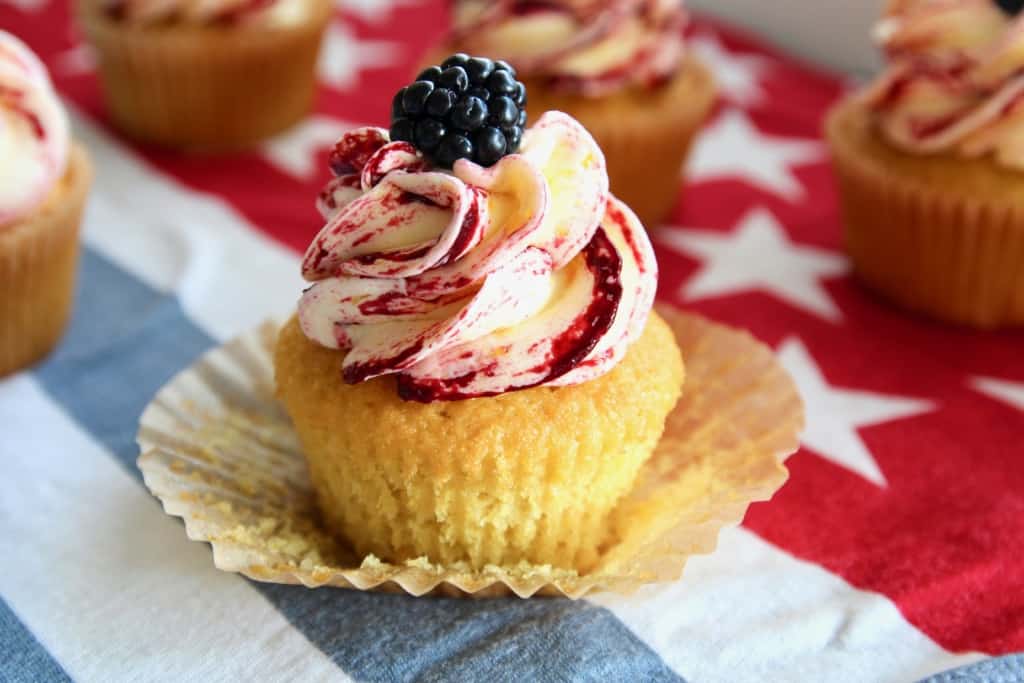 These corn cupcakes are jam packed with corn! There’s corn in the fluffy cupcakes, and corn in the silky buttercream frosting, kissed with tart and fruity blackberries! It’s the perfect cupcake to serve at your Fourth of July BBQ! #corn #corncupcakes #cornmuffins #cornfrosting #frosting #buttercream #blackberry #blackberries #fourthofjuly #fluffy #moist #4thofjuly #independenceday #bbq #barbecue #july #summer
