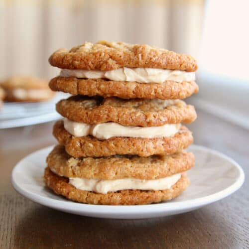 A stack of 3 oatmeal cream pies on a dessert plate.
