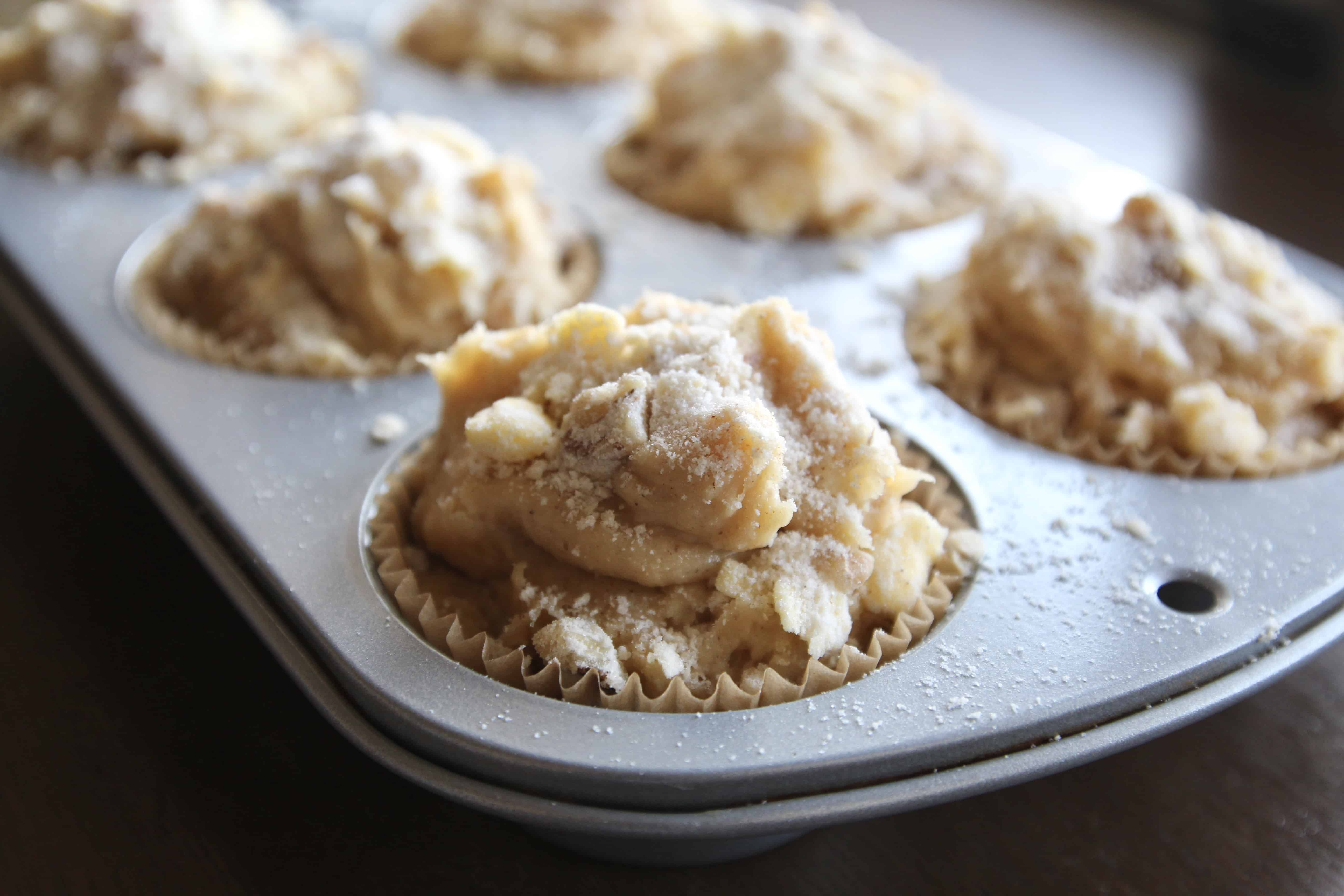 Apple muffin batter in a muffin tin