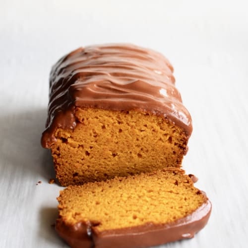 A loaf of Brazilian carrot cake with chocolate frosting.