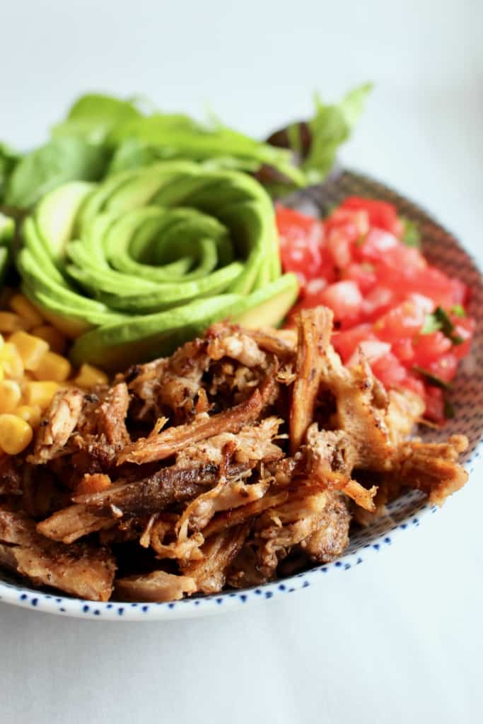 This is THE BEST slow cooker carnitas! So easy to make, yet so tender, crispy, and full of flavor! #carnitas #slowcooker #crockpot #pulledpork #porkshoulder #porkbutt #mexican #mexico #orange #garlic #onions #spices #cilantro #lime #avocado #tacos #arepas #salad #ricebowl #pasta