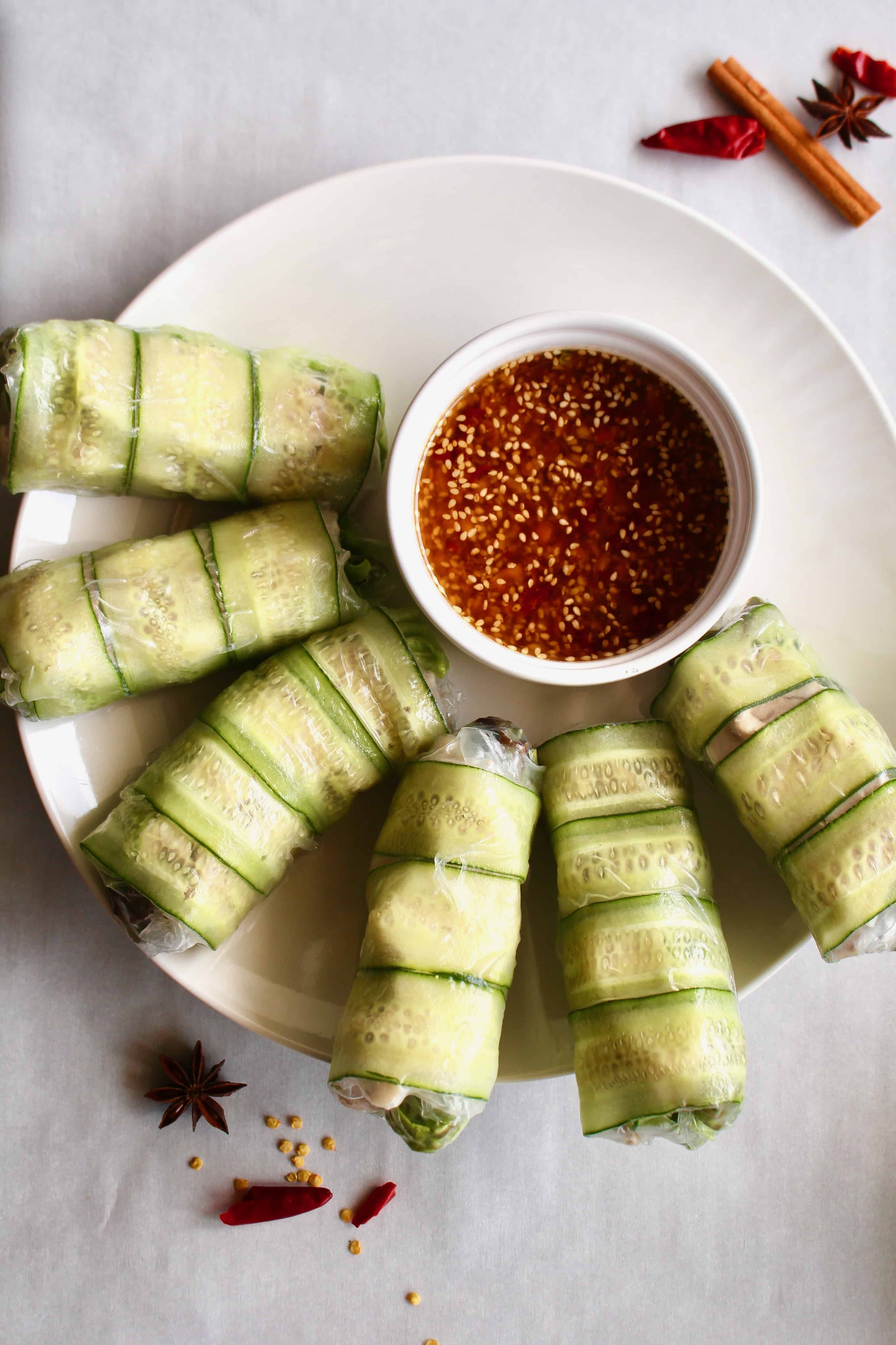 Need a fresh and light appetizer? These spicy chicken summer rolls are perfect! Moist and flavorful chicken is wrapped in rice paper with lettuce and cucumber, served with a spicy Sichuan dipping sauce! #summerrolls #springrolls #ricepaper #chicken #chickenthigh #chinese #sichuan #spicy #healthy #lettucewraps #appetizer #fresh #light #partyfood #asian