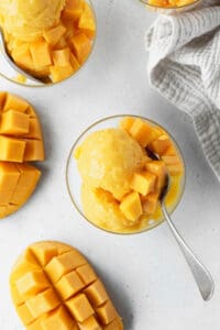 Mango sorbet ice cream with fresh mango chunks