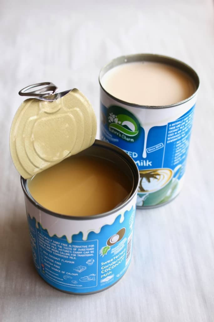 Opened cans of Nature's Charm condensed coconut milk and evaporated coconut milk
