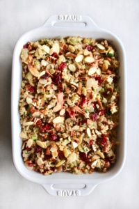 This rice stuffing with jackfruit is truly THE BEST stuffing ever! It’s both vegan and gluten free so everyone can enjoy it, making it perfect for the holidays when you have guests with different dietary restrictions. Full of brown rice, vegetables, cranberries, nuts, and jackfruit confit, there’s so much flavor in this stuffing you won’t be missing the meat! This is sure to be your new go to stuffing recipe for Thanksgiving and Christmas! #rice #ricestuffing #stuffing #thanksgiving #christmas #dinner #glutenfree #vegan #vegetarian #brownrice #easy #jackfruit #meatsubstitute #meatless #holidays #fall #winter #recipe #beststuffing #cranberries #almonds #pecans