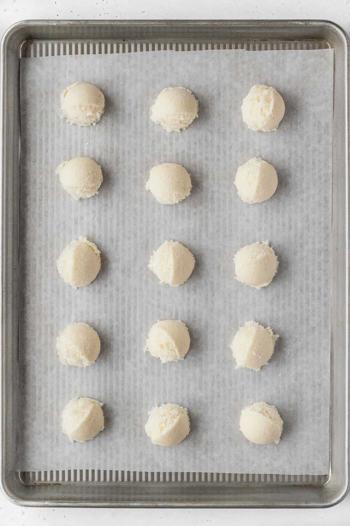 Vegan  macaroon dough on a parchment paper lined baking sheet.