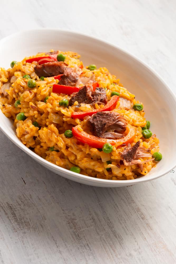 Vegan arroz valenciana is a plant based twist on the classic hearty Filipino dish using rice, coconut milk, jackfruit confit, and saffron! Full of flavor and vegetables, it tastes healthy yet creamy and decadent!