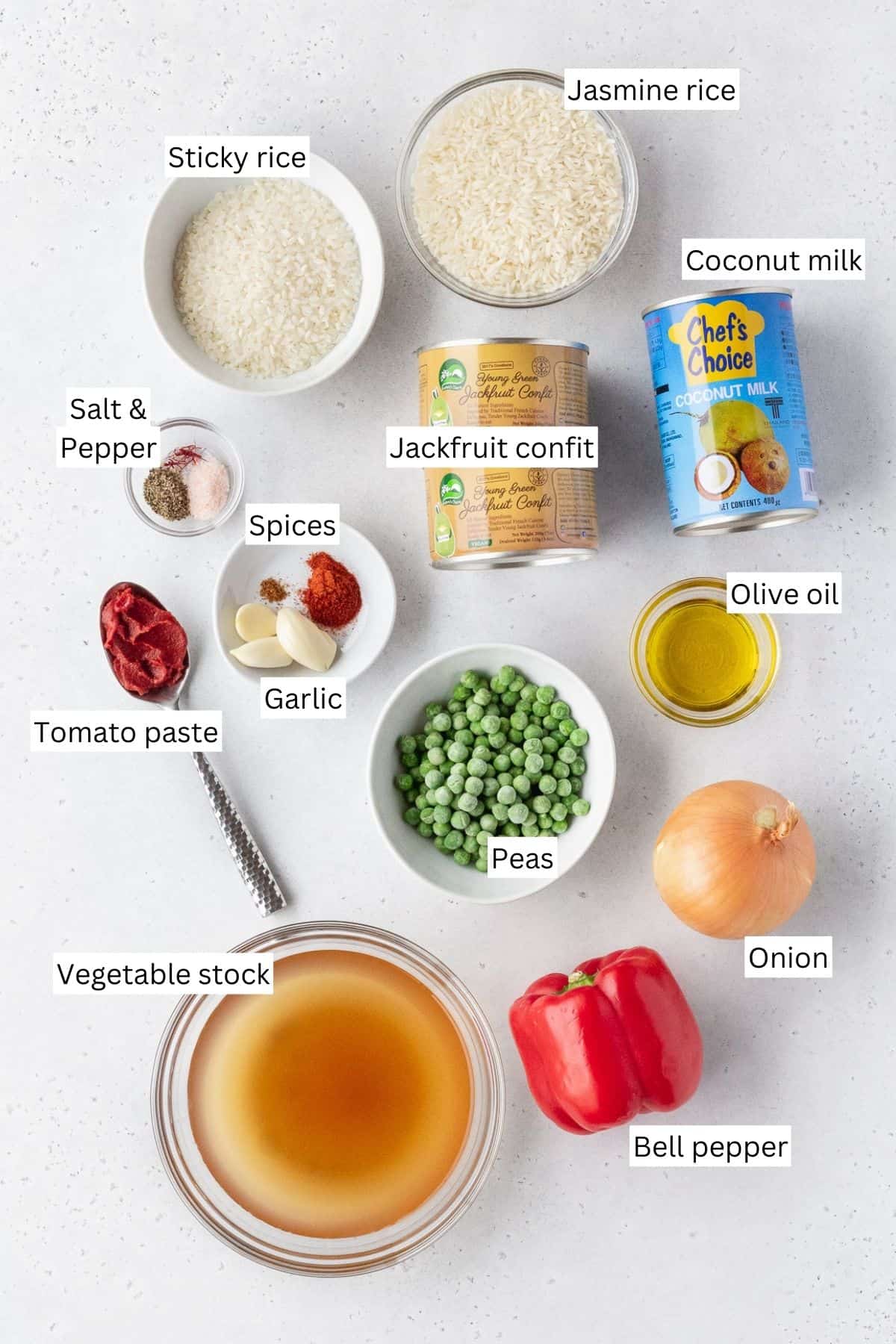 Ingredients for making vegan Arroz Valenciana laid out on a table with text overlay.