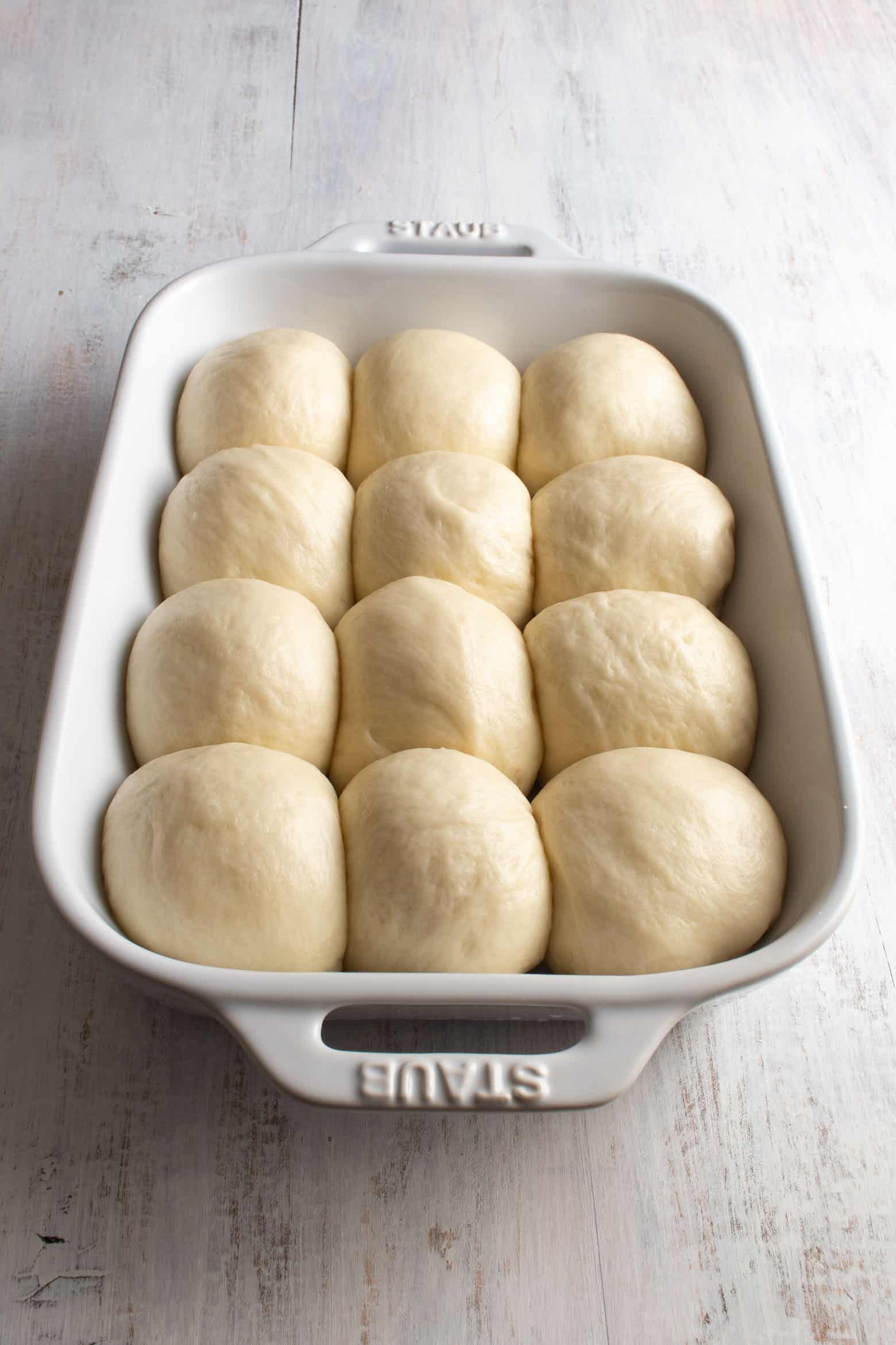 Balls of risen dough in a baking pan