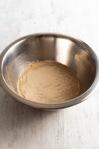 Activate the yeast by sprinkling it over some warm water and sugar