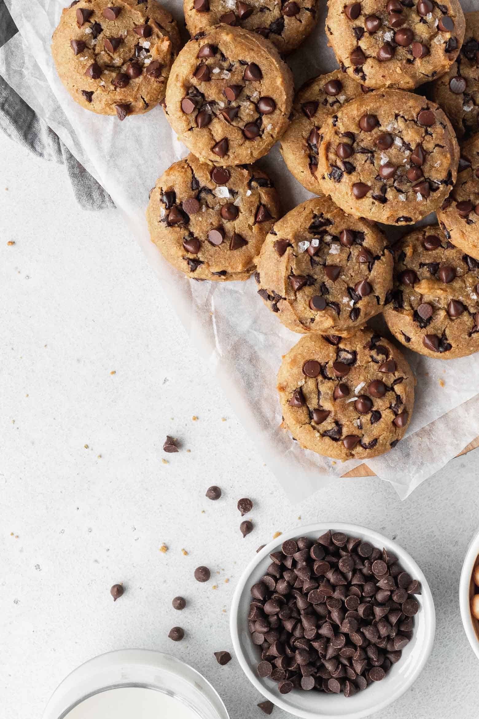 Many gluten-free chocolate chip cookies on parchment paper
