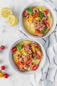 This vegan grits recipe is the perfect gluten-free meal! Creamy vegan polenta cooked in coconut milk is topped with savory jackfruit confit with tomatoes and basil!