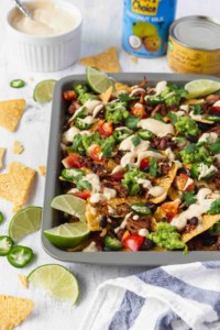 Pulled Jackfruit Nachos with Cheesy Vegan Queso 10 Vegan nachos with jackfruit and vegan queso is amazing! Tortilla chips, jackfruit, black beans, tomatoes, guacamole, jalapeños, cilantro, and creamy queso! #vegannachos #vegancheese #veganqueso #jackfruit #veganmexicanfood