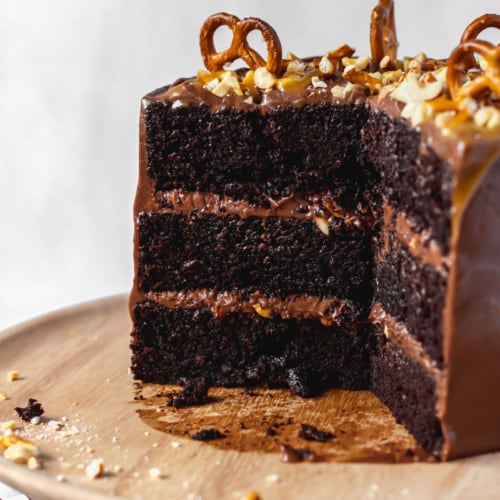 Moist and fluffy chocolate cake with peanuts, pretzels, and chocolate buttercream frosting