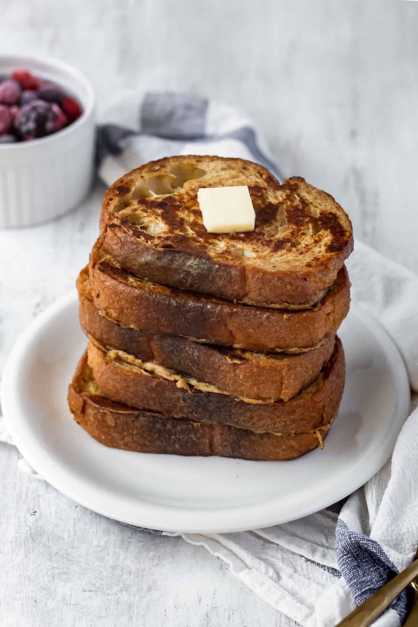 Vegan french toast is easy to make and shockingly delicious! Made with coconut milk and chickpea flour, it's perfect for breakfast or brunch! #veganfrenchtoast #veganbreakfast #veganbrunch #plantbasedmeals #frenchtoast