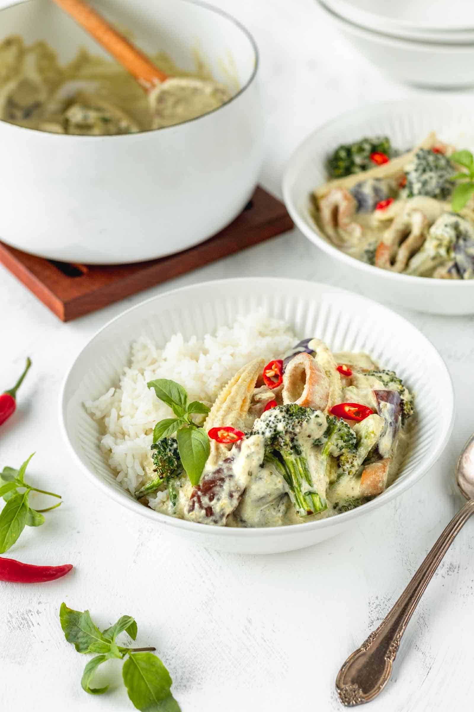bowl of vegan green curry with mushroom calamari and jasmine rice