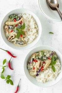 two bowls of jasmine rice with green curry