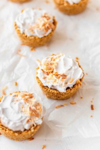 Individual coconut cream pies on parchment paper