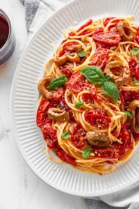 Plate of pasta with roasted tomatoes and vegan calamari