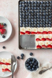 A pan of patriotic flag cookie cake with a slice taken out
