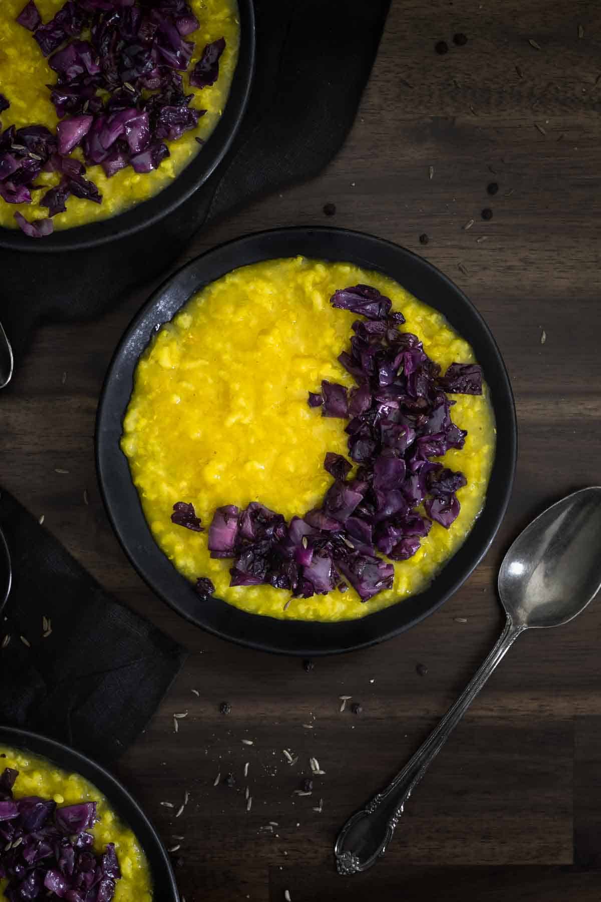 A bowl of rice and lentil porridge with red cabbage