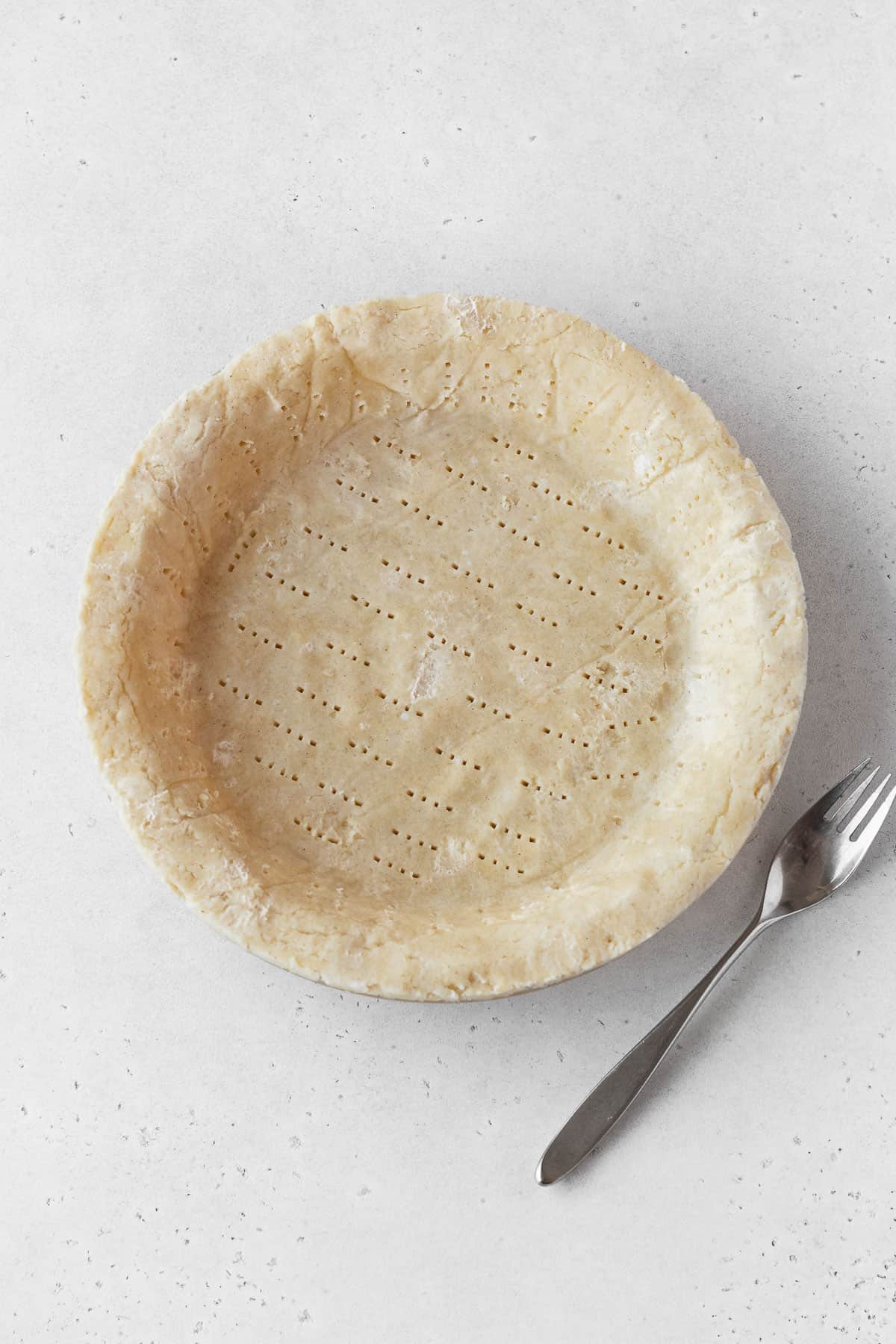 Pie dough pressed into a pie plate.