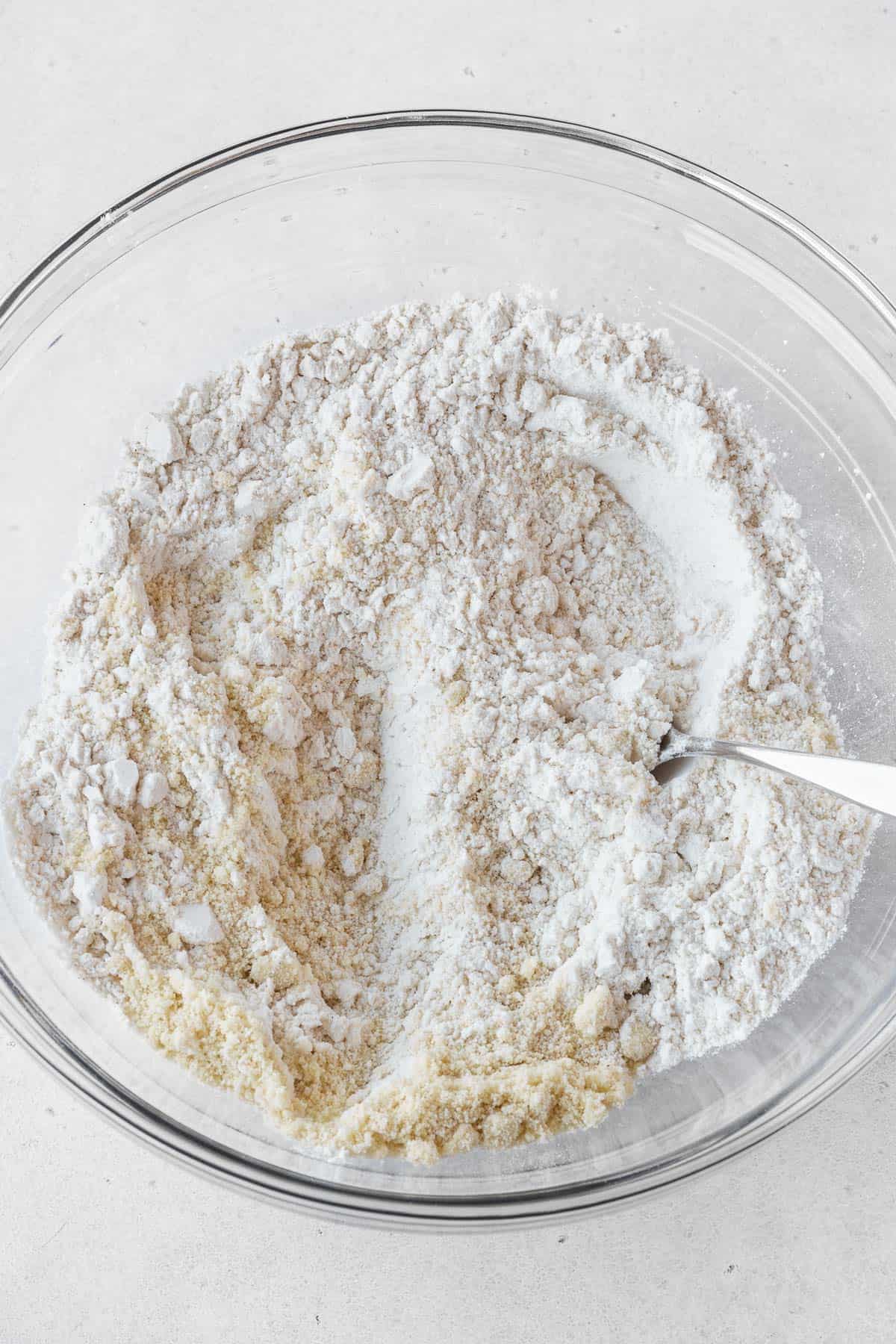 Dry ingredients for dairy-free pie crust mixed together in a glass bowl.