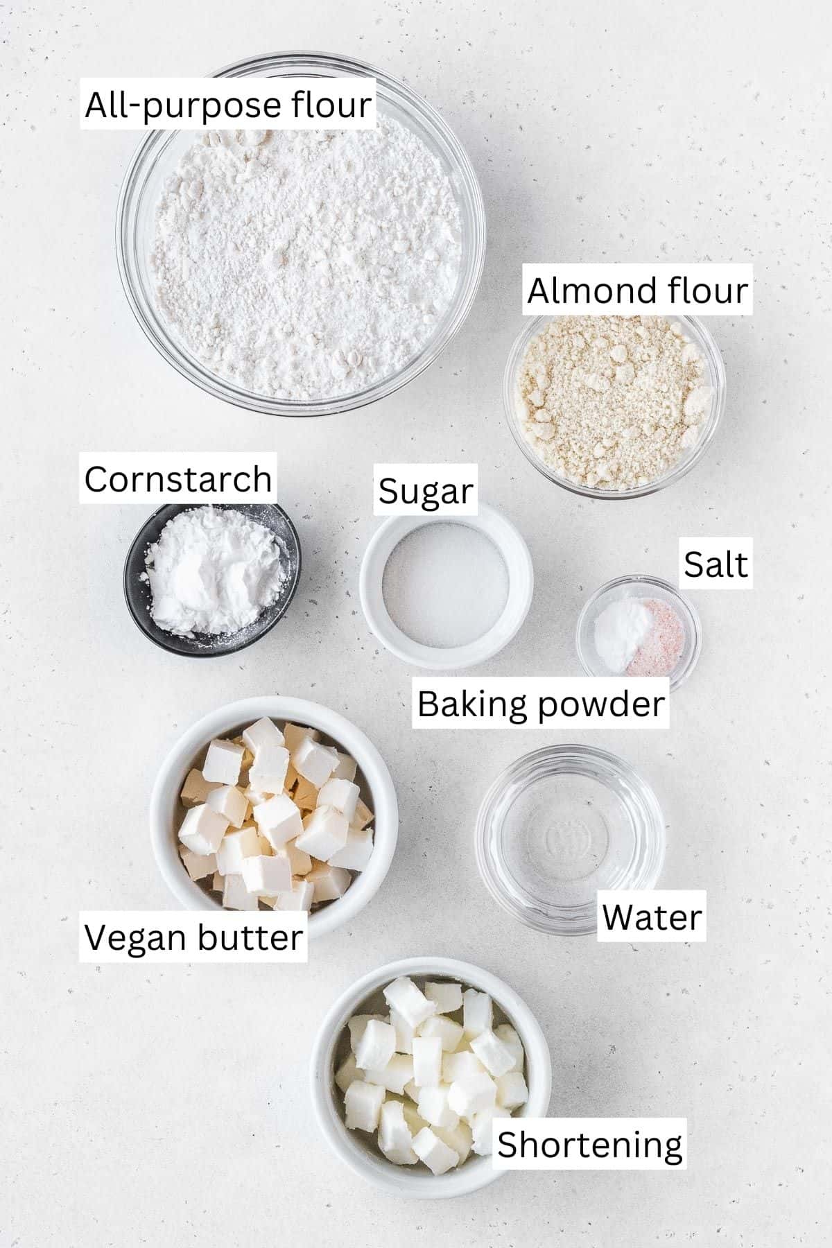 Ingredients for making dairy-free pie crust measured out into bowls.