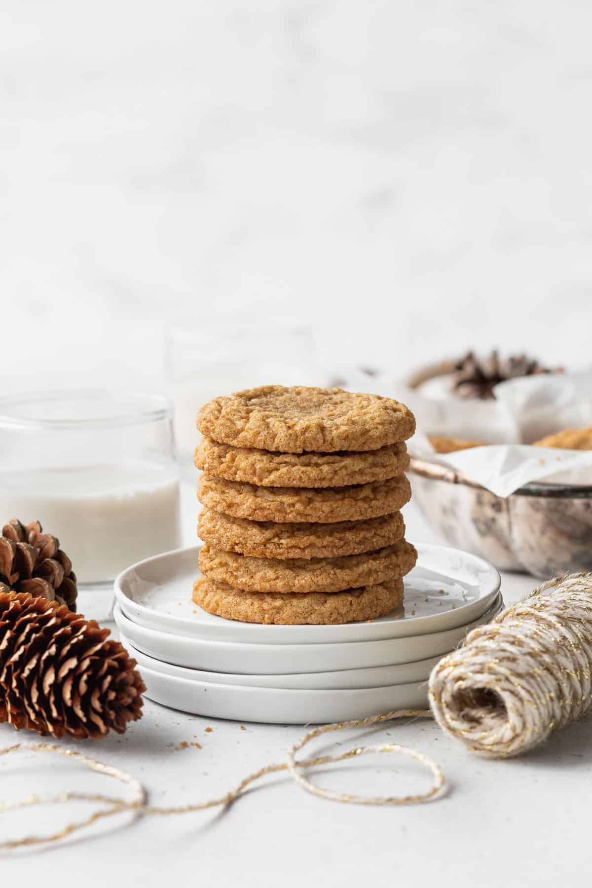 A stack of ginger cookies on white plates.