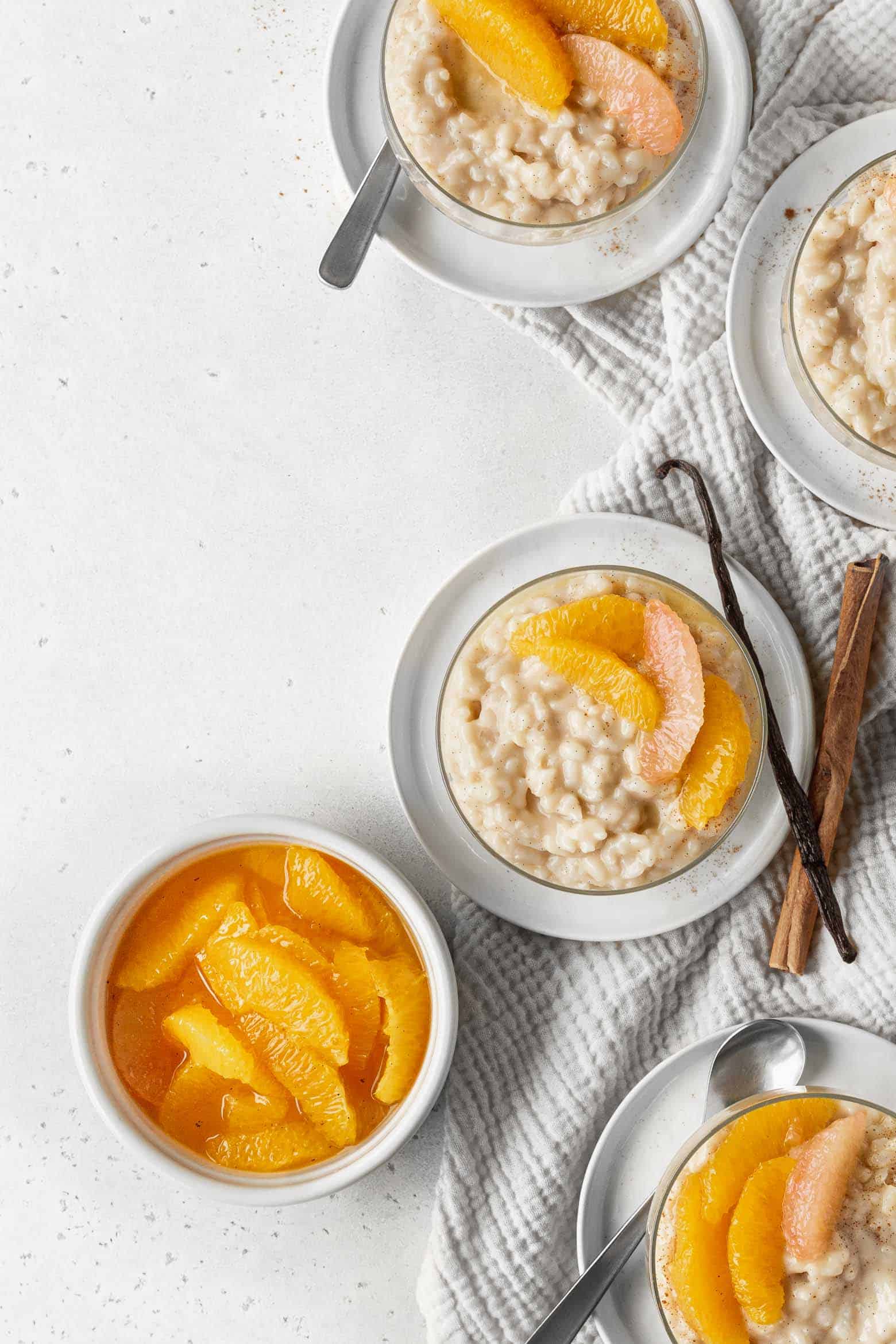 Bowls of rice pudding topped with oranges