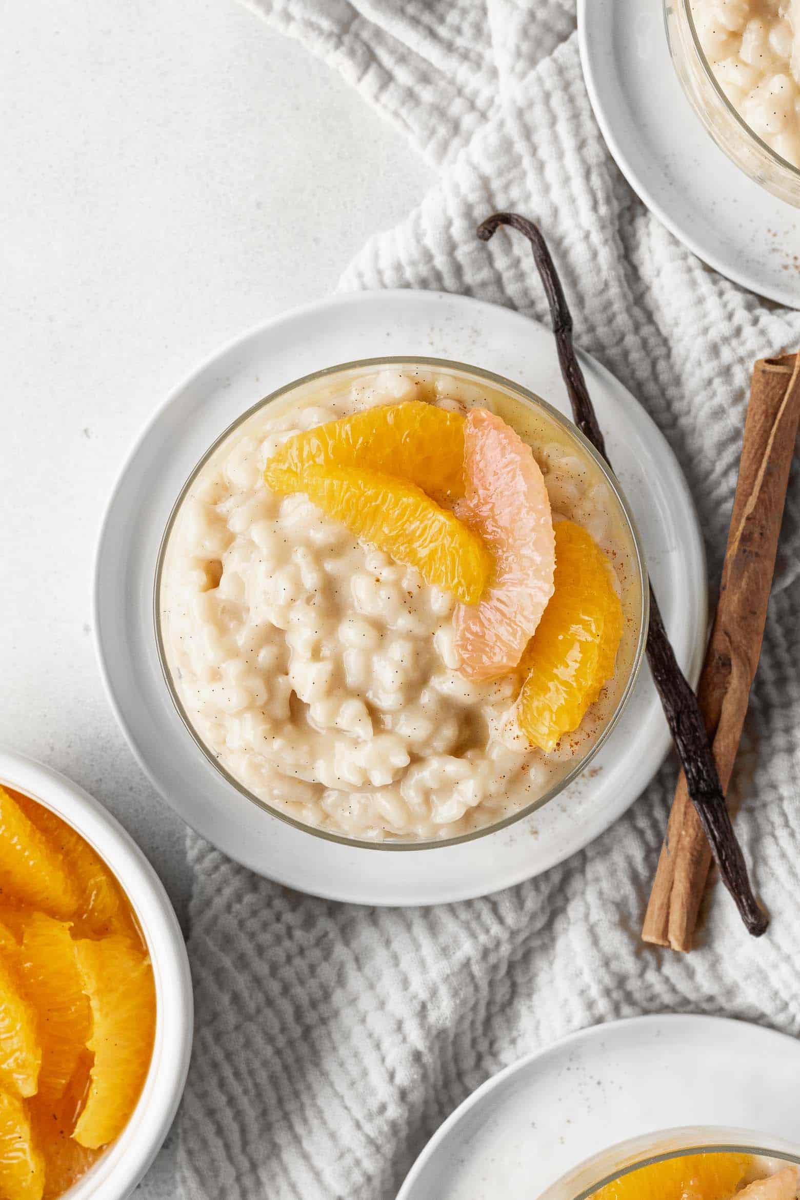 A bowl of vegan rice pudding with orange compote on top
