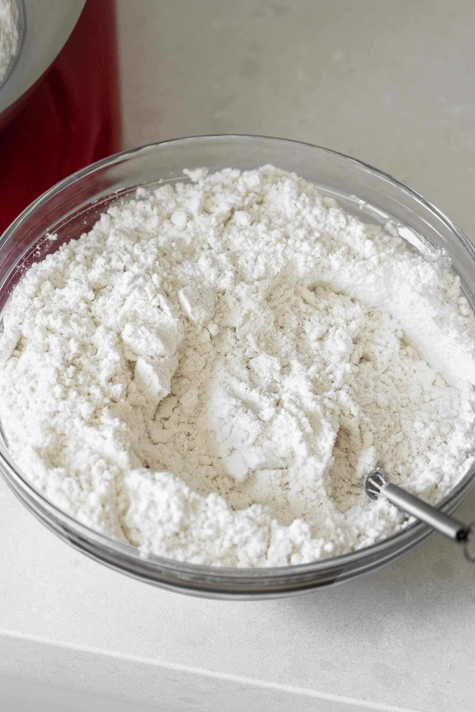 Flour, salt, baking soda, and baking powder mixed together in a bowl.