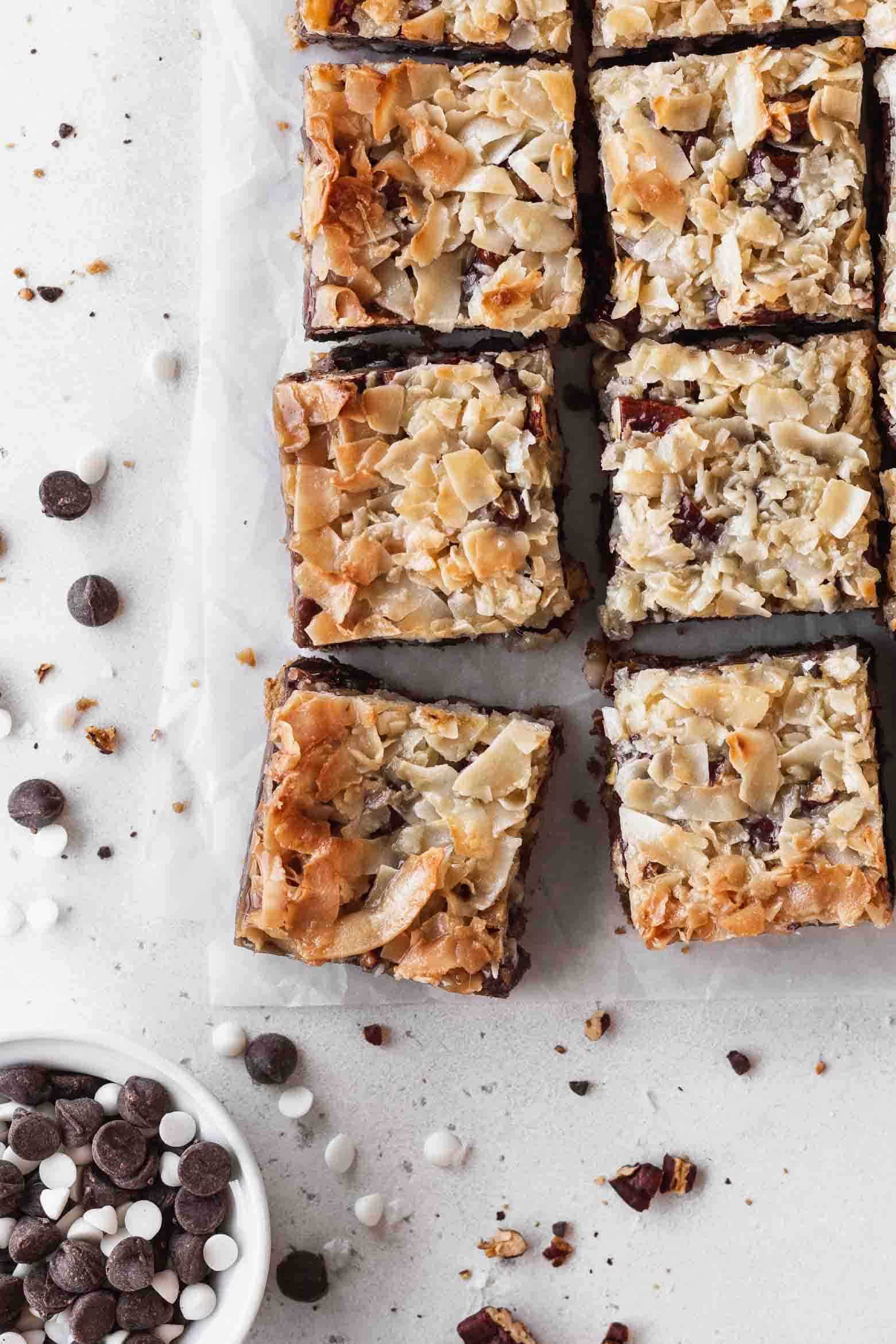 7 layer magic bars with a dish of chocolate chips.