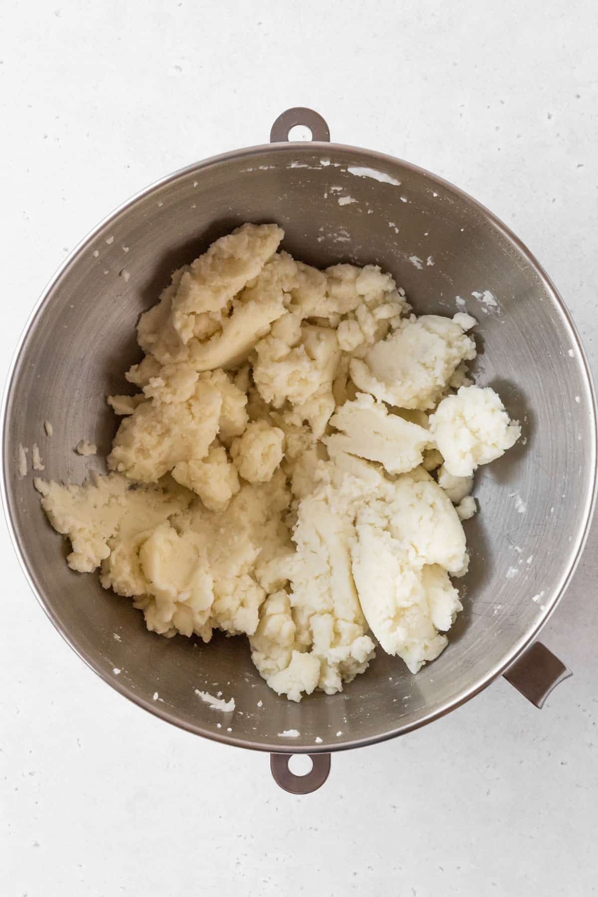 Potato mash mixture is thick and looks slightly crumbly.
