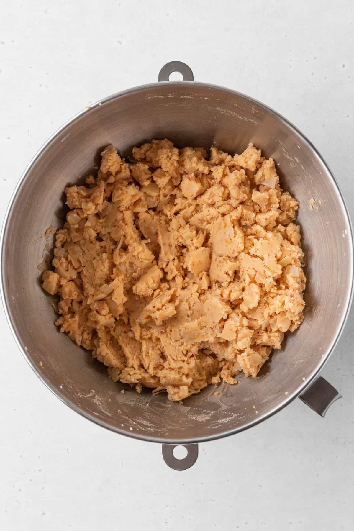 Vegan potato croquette mixture is pale orange and thick.