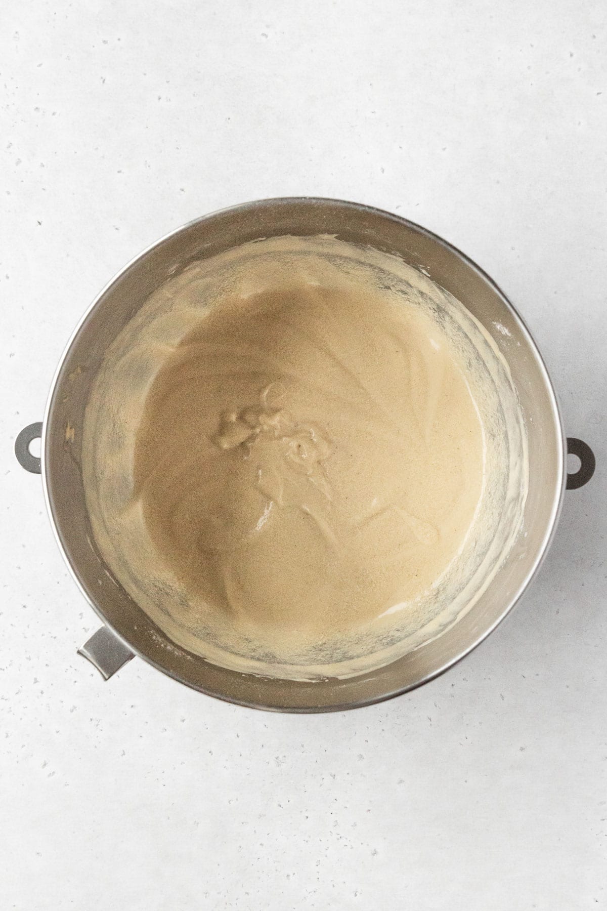 Gluten-free coffee cake batter is much thinner and smoother after the addition of milk.