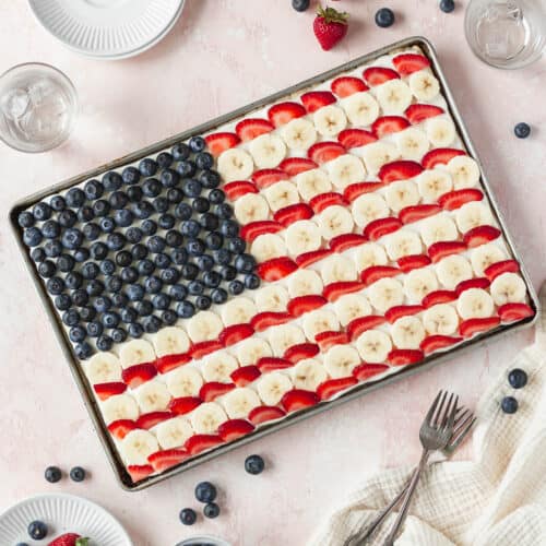A square image of the entire sheet pan of gluten free and dairy free American flag dessert pizza with blueberries, bananas, and strawberries.