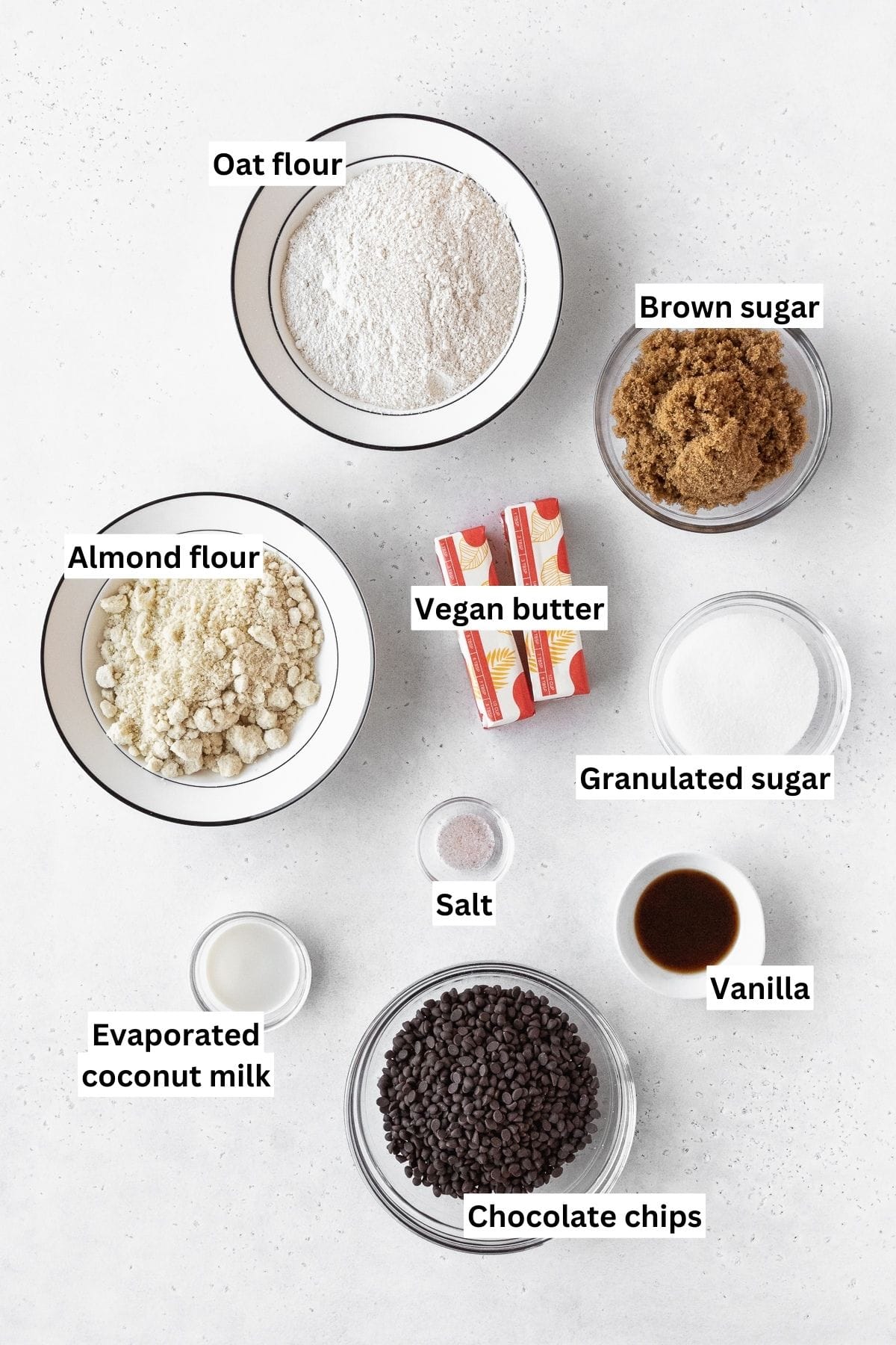 Ingredients needed to make dairy-free edible sugar cookie dough measured out on a white table.