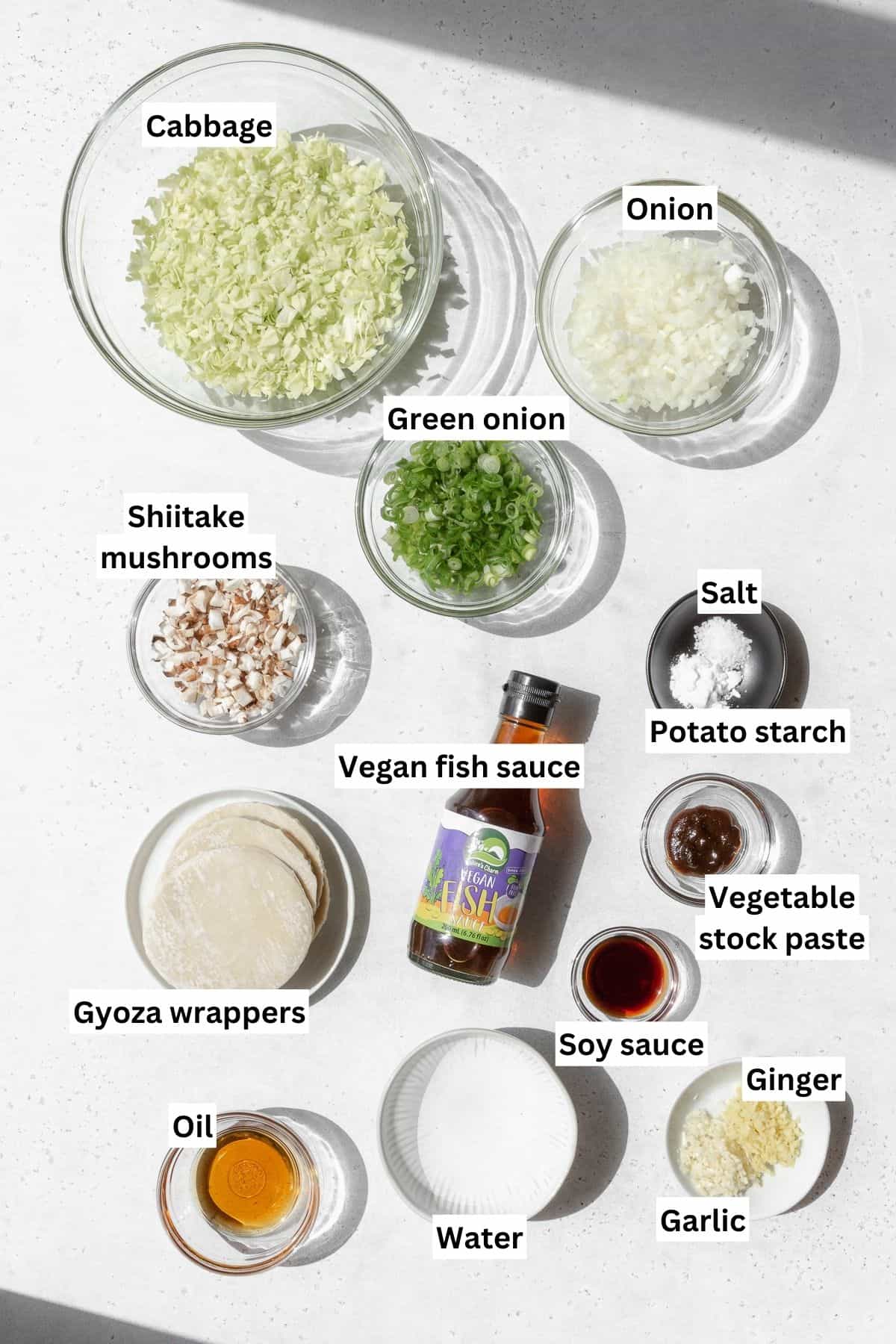 Overhead shot of vegan gyoza ingredients measured out into bowls.