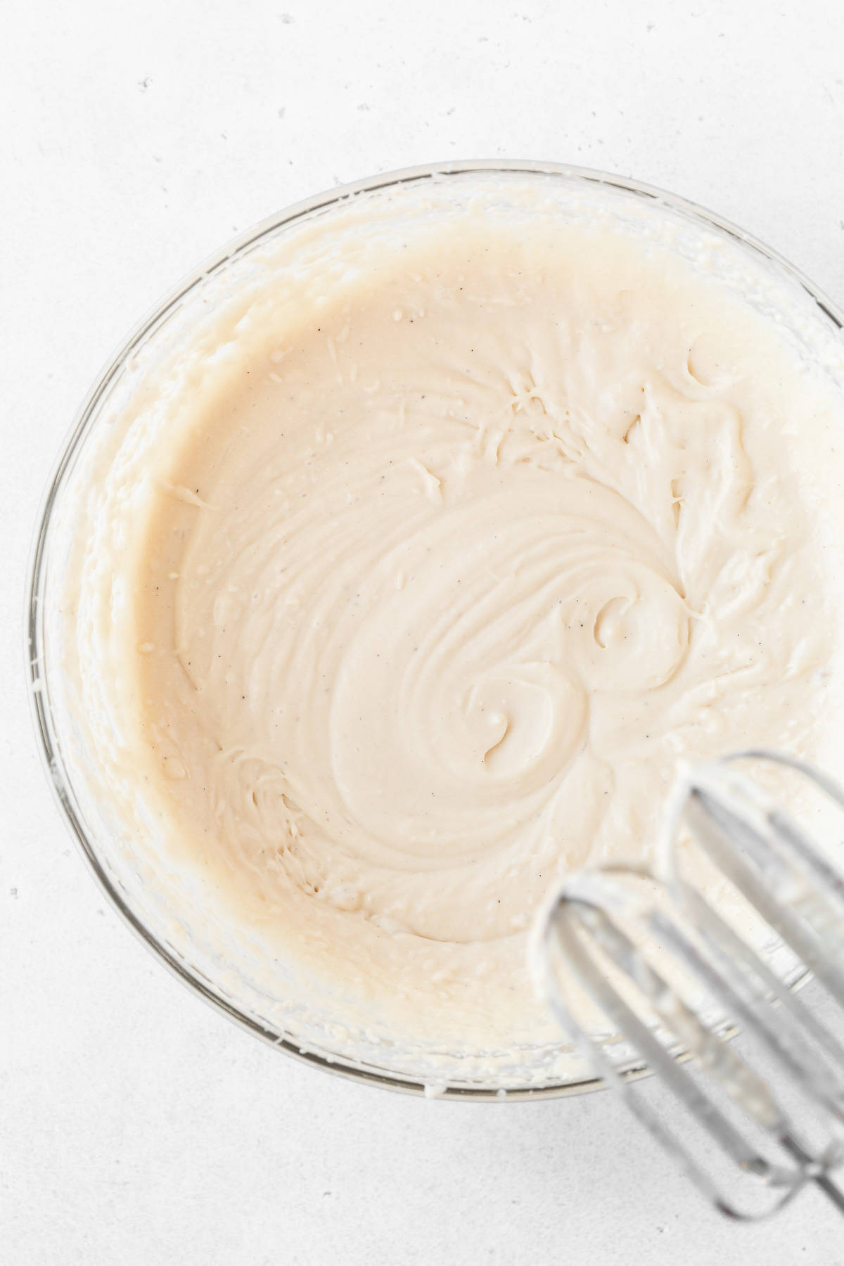 The dairy-free ice cream base in a glass mixing bowl before freezing.